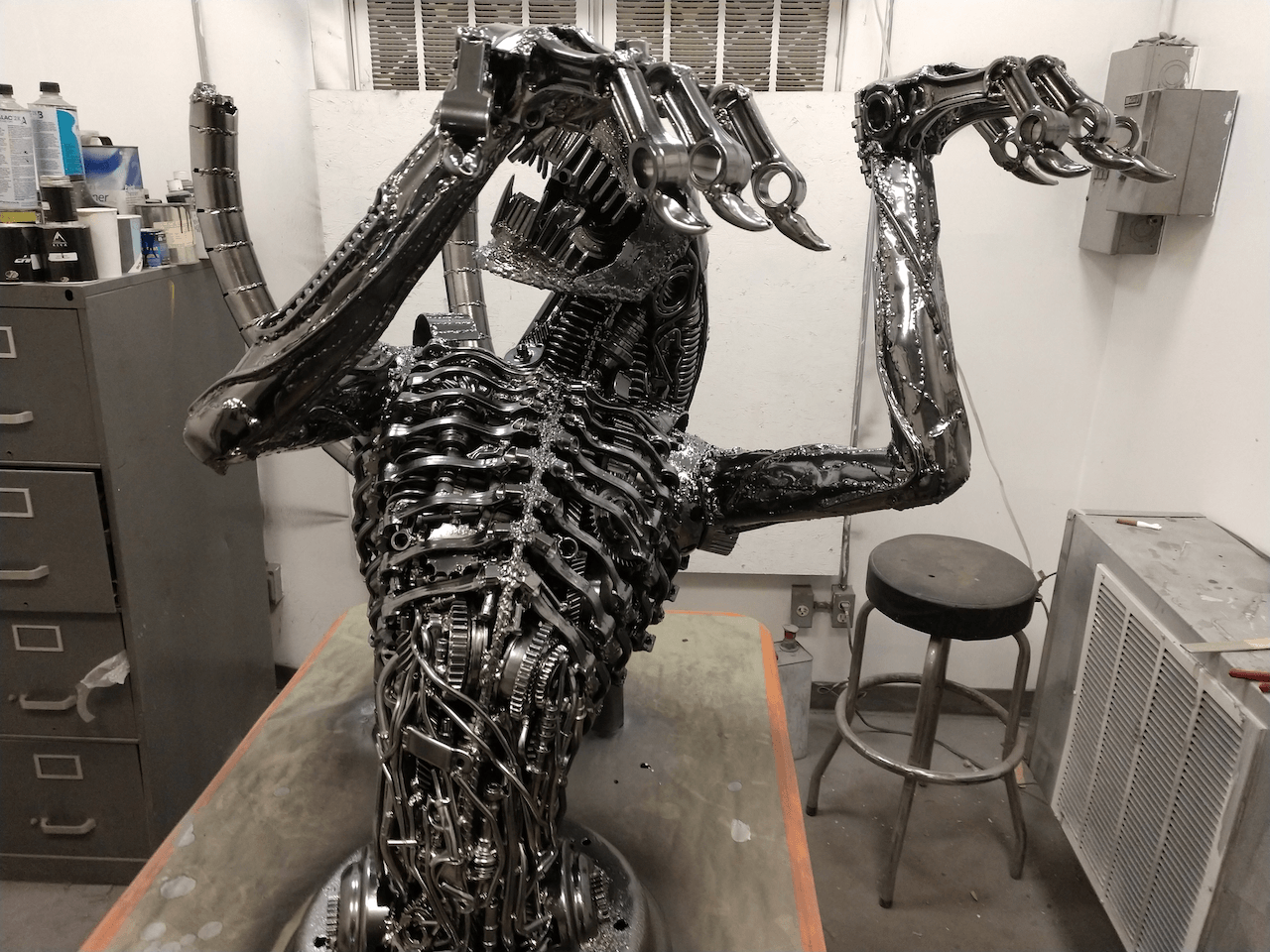 A statue of an alien is sitting on a table in a room