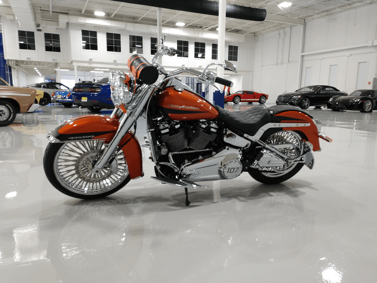 A red harley davidson motorcycle is parked in a garage.