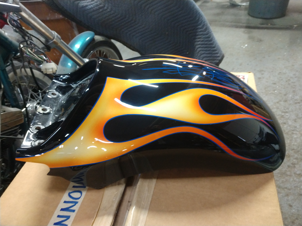 A motorcycle fender with flames painted on it