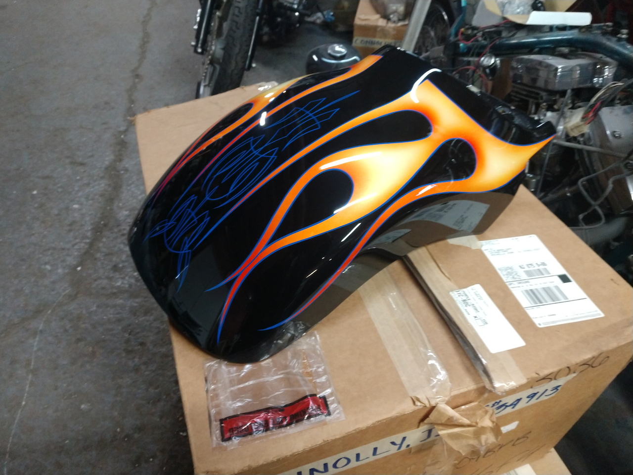 A motorcycle fender with flames painted on it