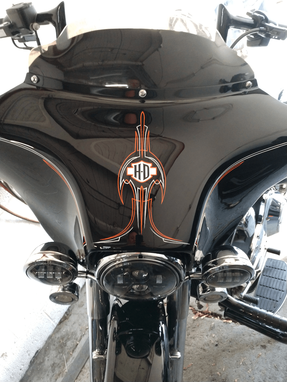 A black harley davidson motorcycle is parked in a garage