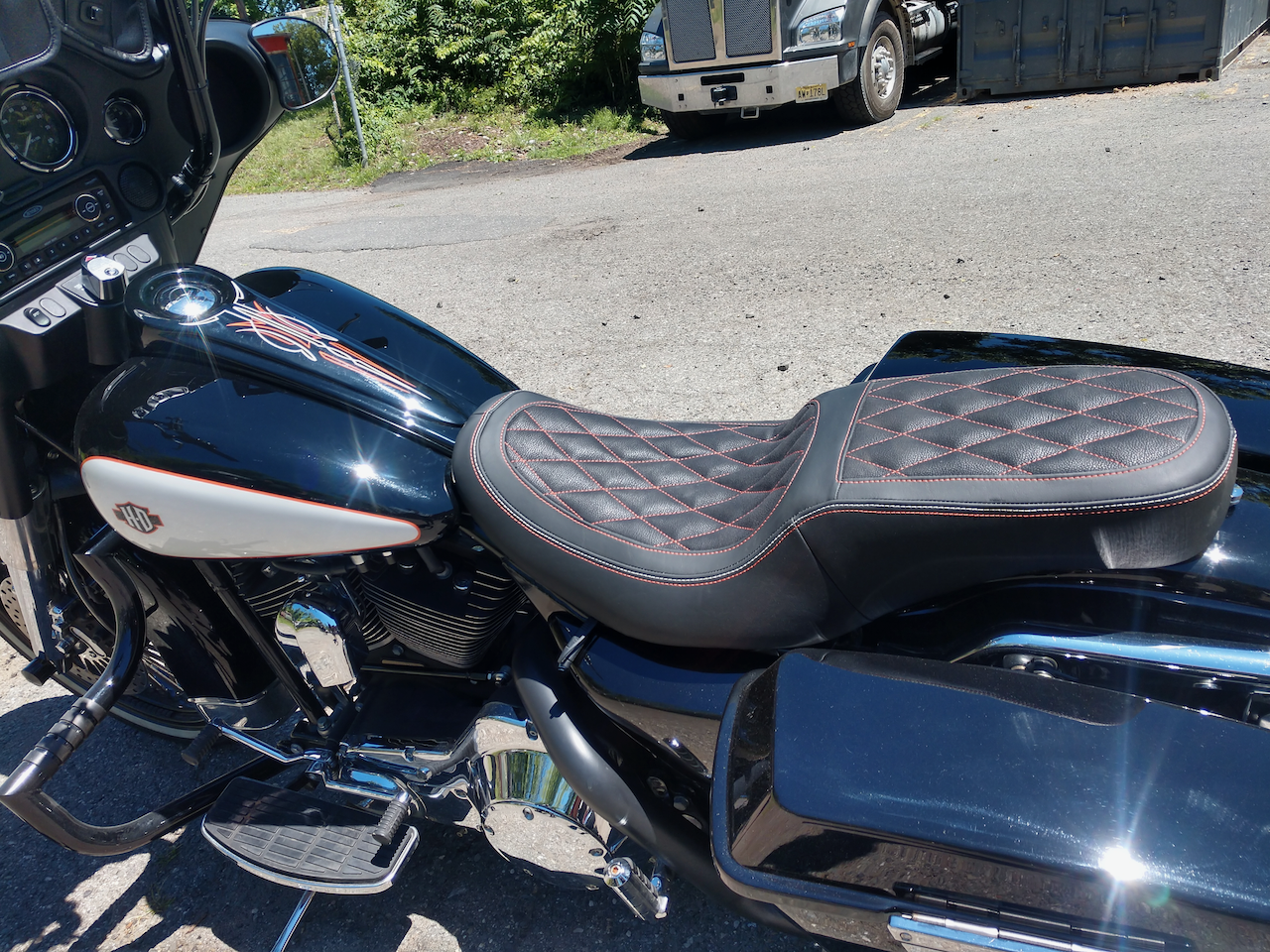 A black harley davidson motorcycle is parked on the side of the road.