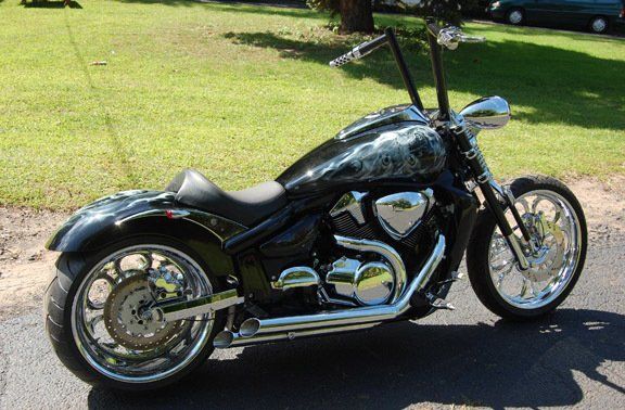 A black motorcycle is parked on the side of the road