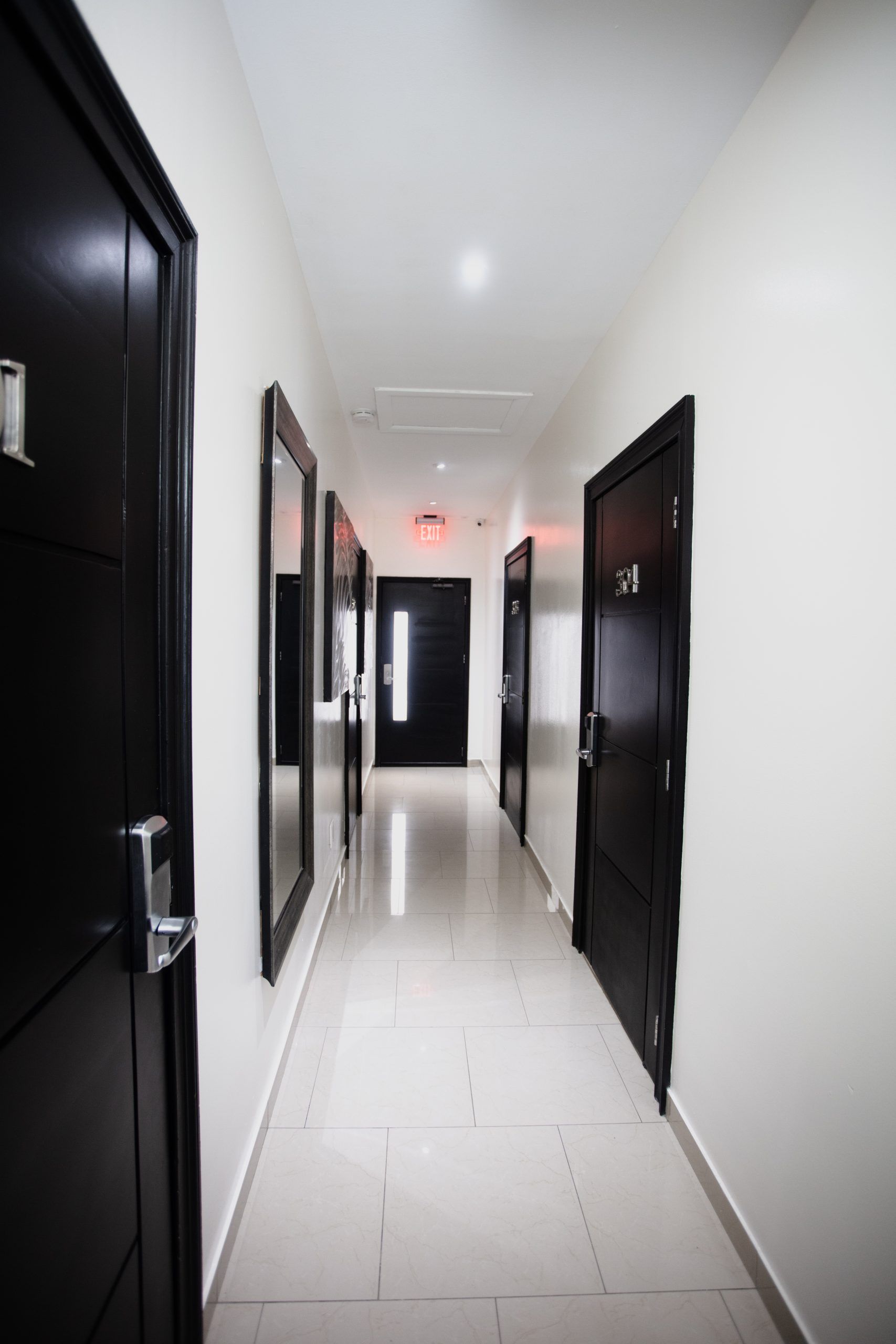 Restaurant dining area with tables, chairs, and a booth.  Neutral colors with orange and blue accents.  Empty.