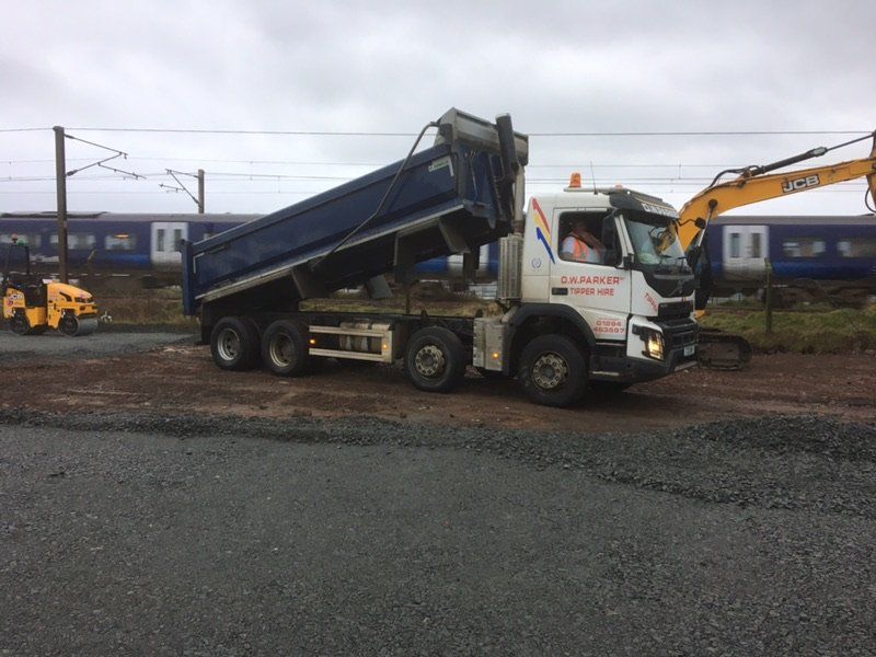 White truck with raised trailer