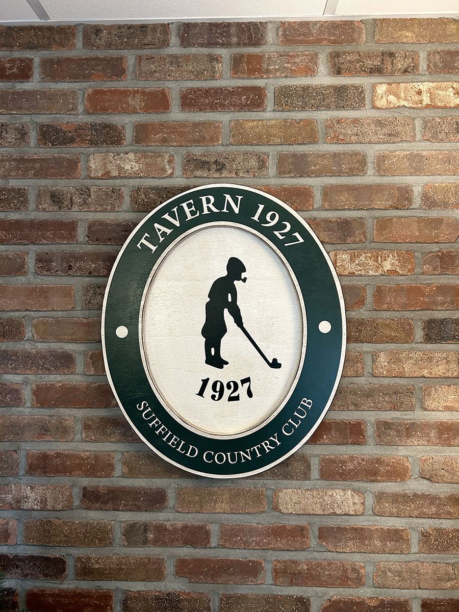 A sign on a brick wall that says tavern 1927