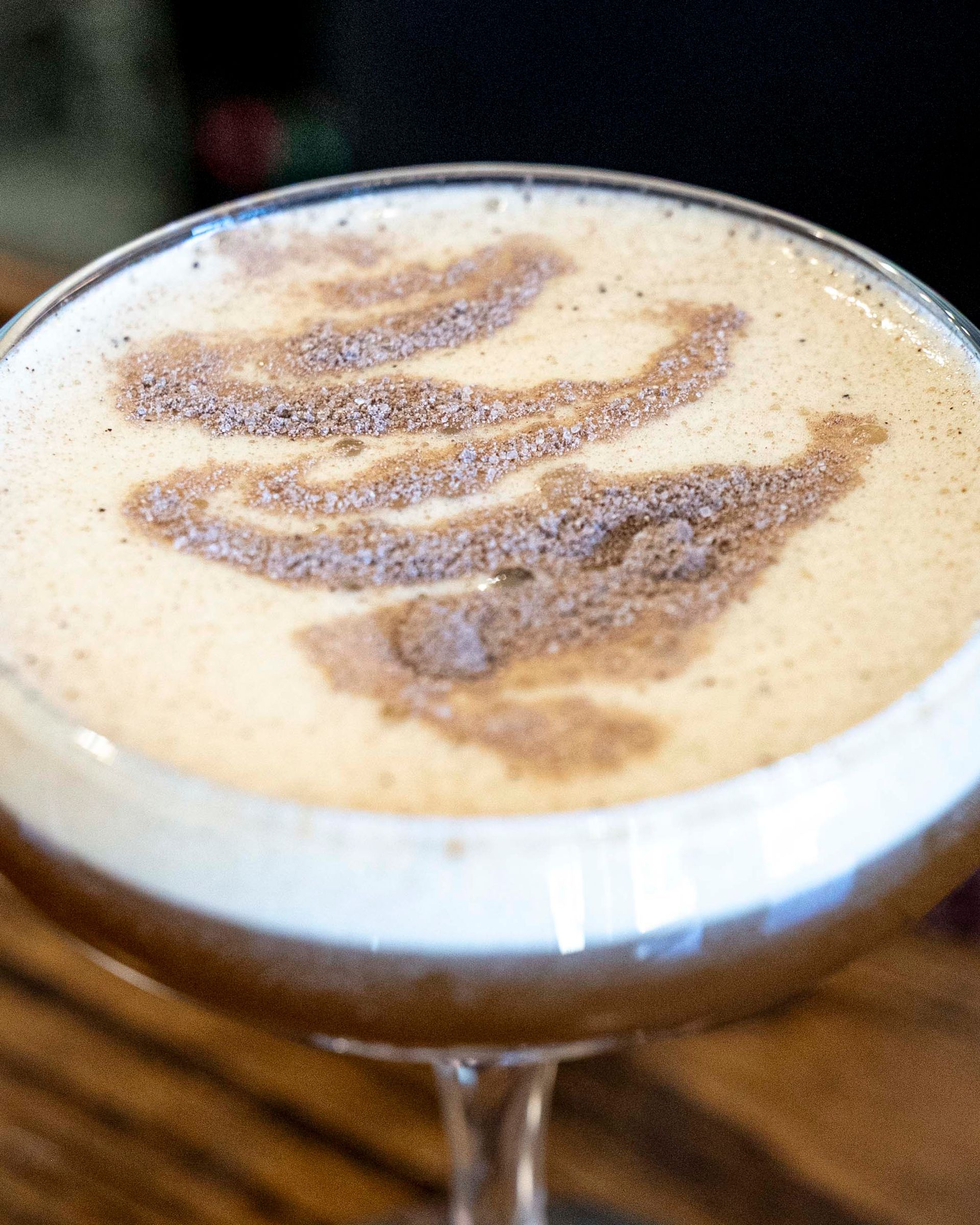 A martini glass with a cinnamon swirl on top