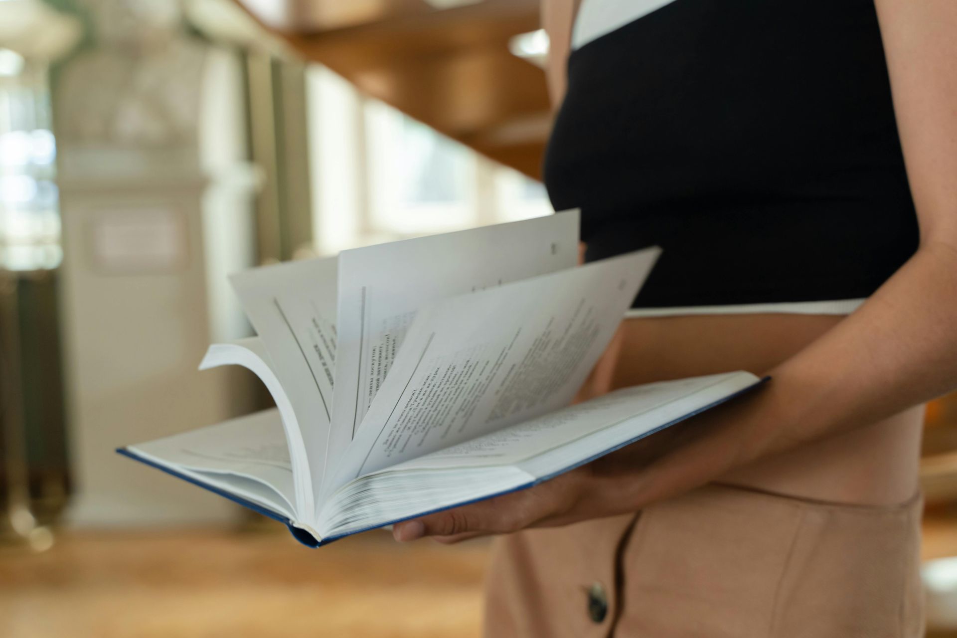 A close-up, angled view of a folded newspaper resting on a wooden surface, with a shallow depth of field.
