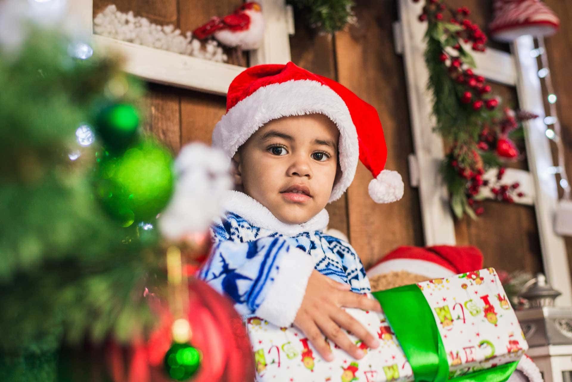 A little girl is sitting at a table with a birthday cake.