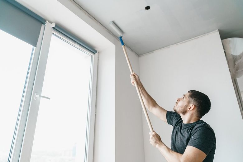 man painting the ceiling