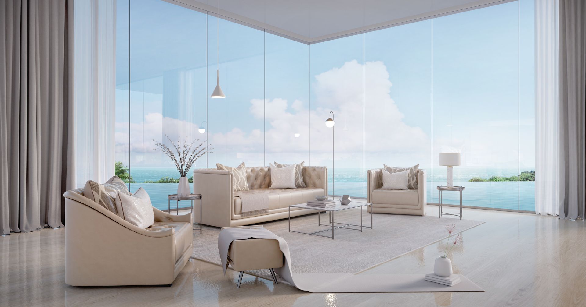 A living room with a couch , chair , coffee table and large windows overlooking the ocean.