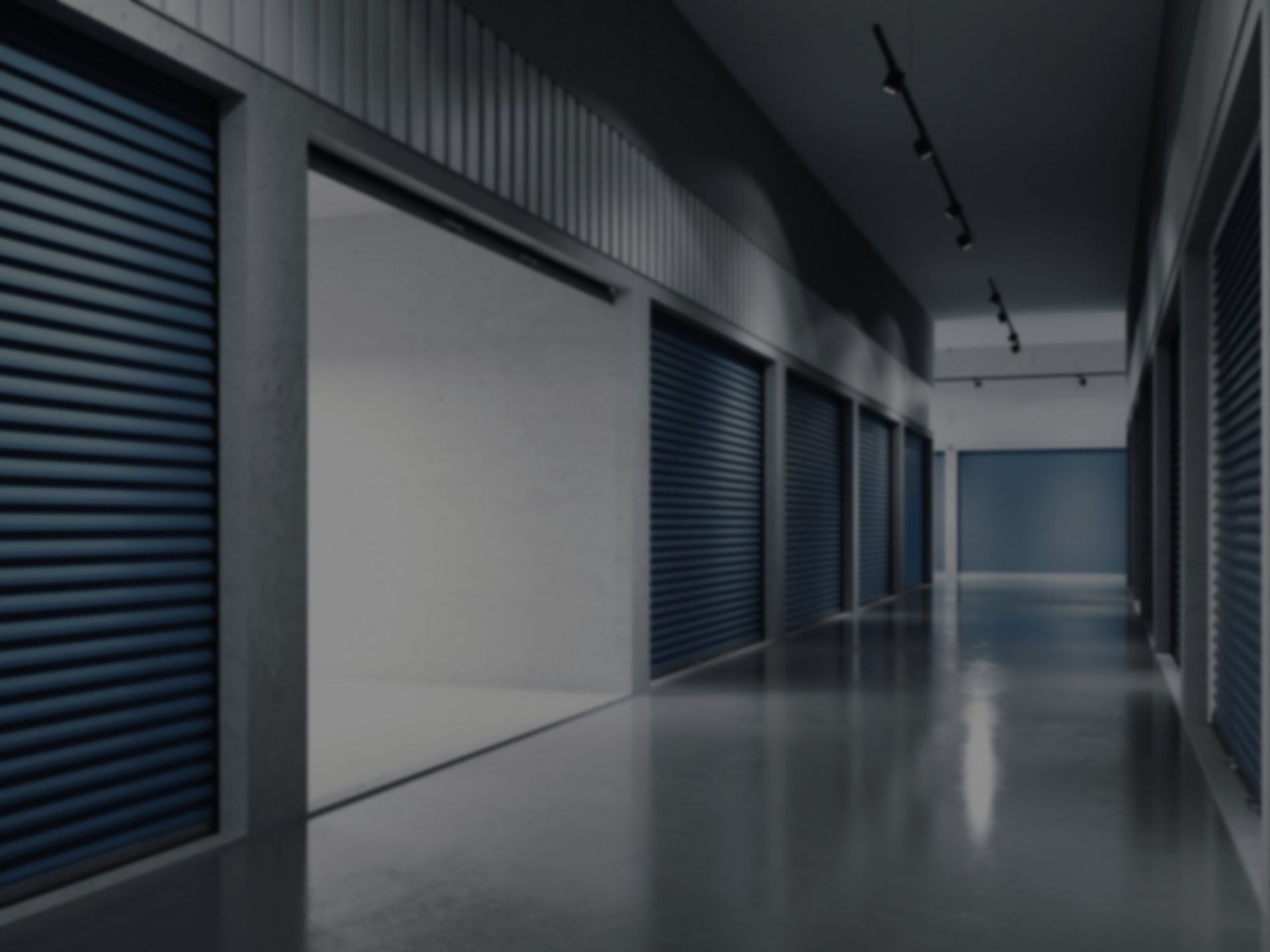 A long hallway filled with lots of storage units with blue doors.