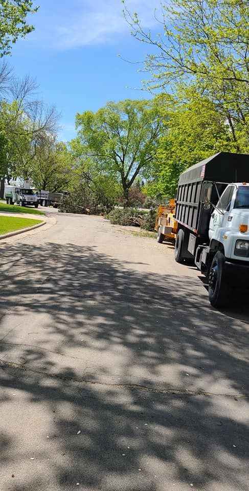 A dump truck is parked on the side of the road.