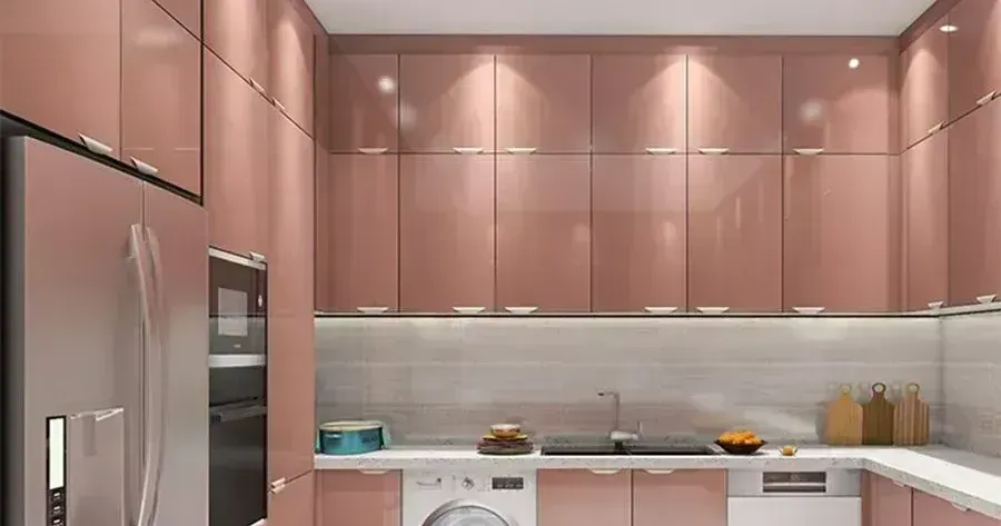 A kitchen with pink cabinets and appliances