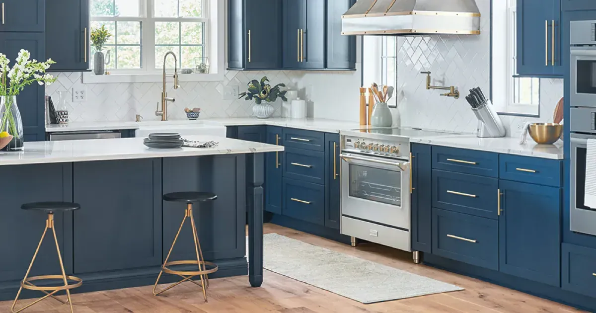 A kitchen with blue cabinets and stainless steel appliances.