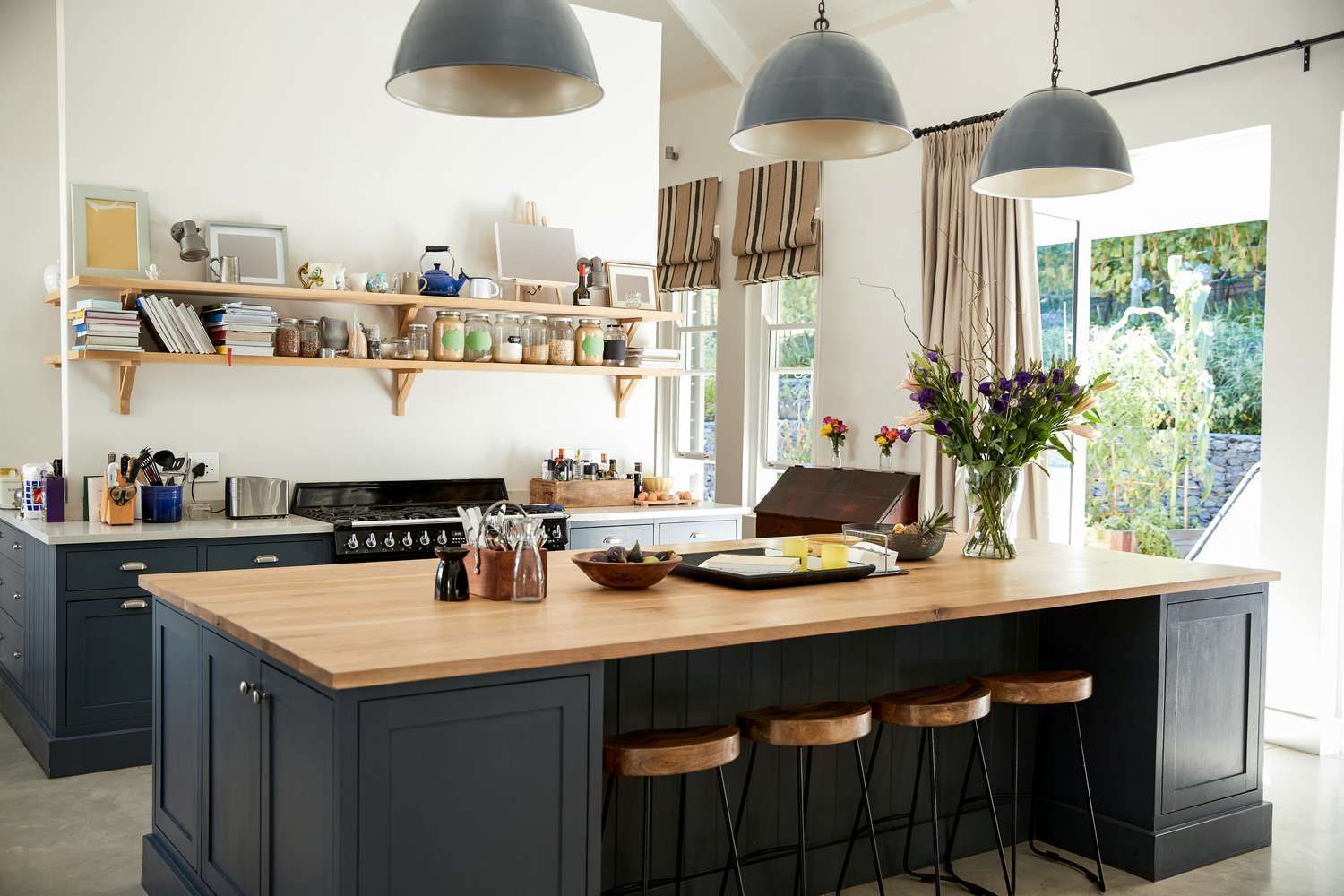 A kitchen with a large island and stools.