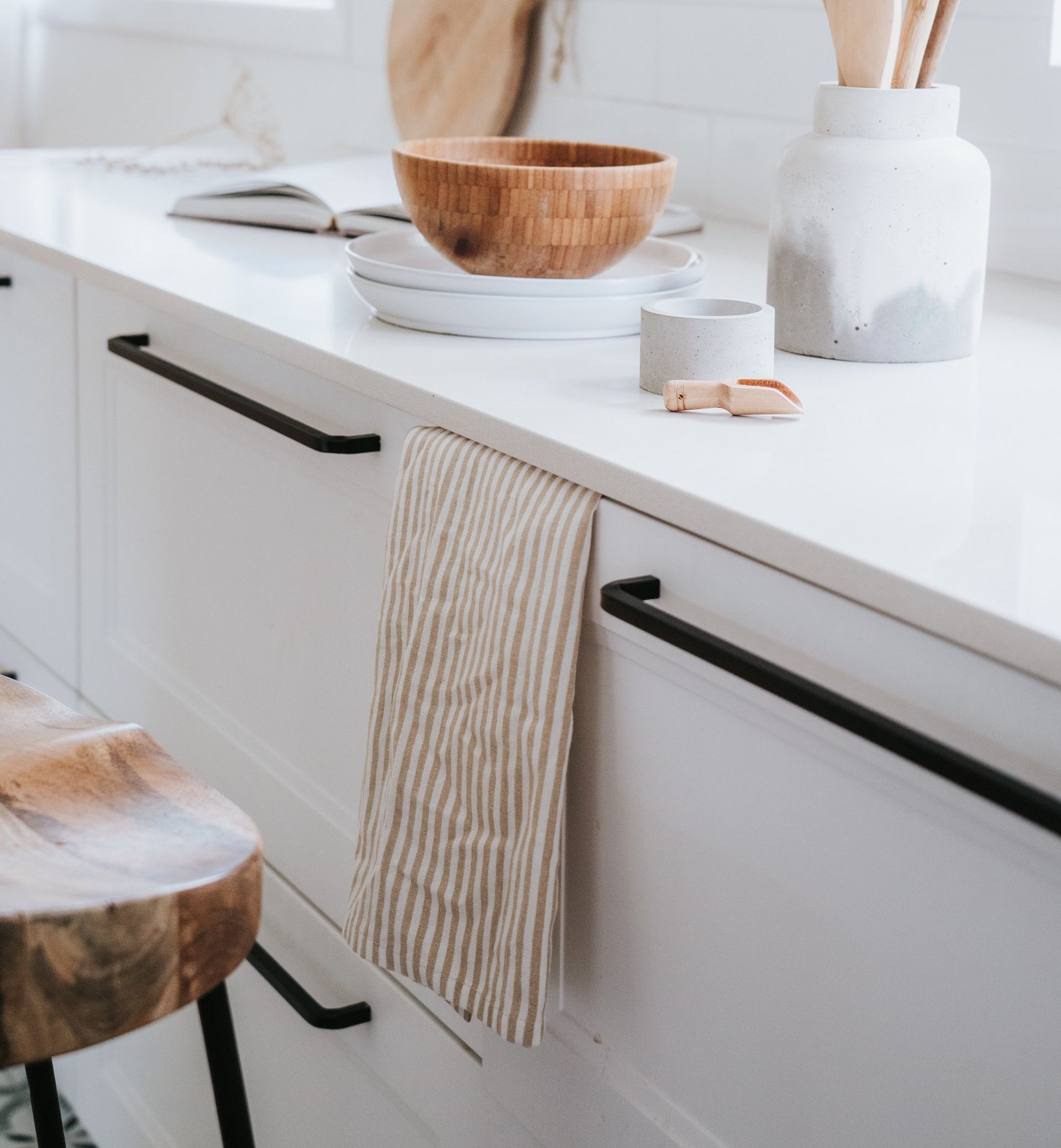 A kitchen counter with a wooden bowl on top of it