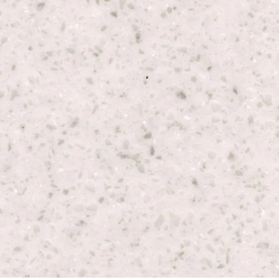 A close up of a white granite counter top.