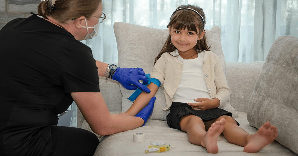 A TapLabs technician does bloodwork with a child in the comfort of her home
