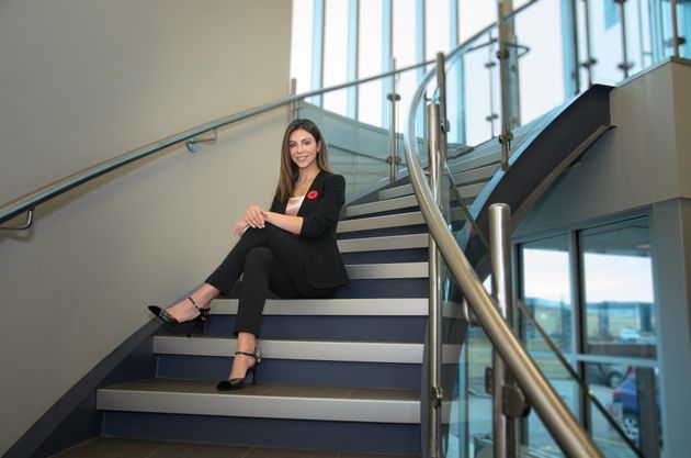Kelly Kuzel CEO and Founder of TapLabs sitting on the stairs at BioHub in Calgary
