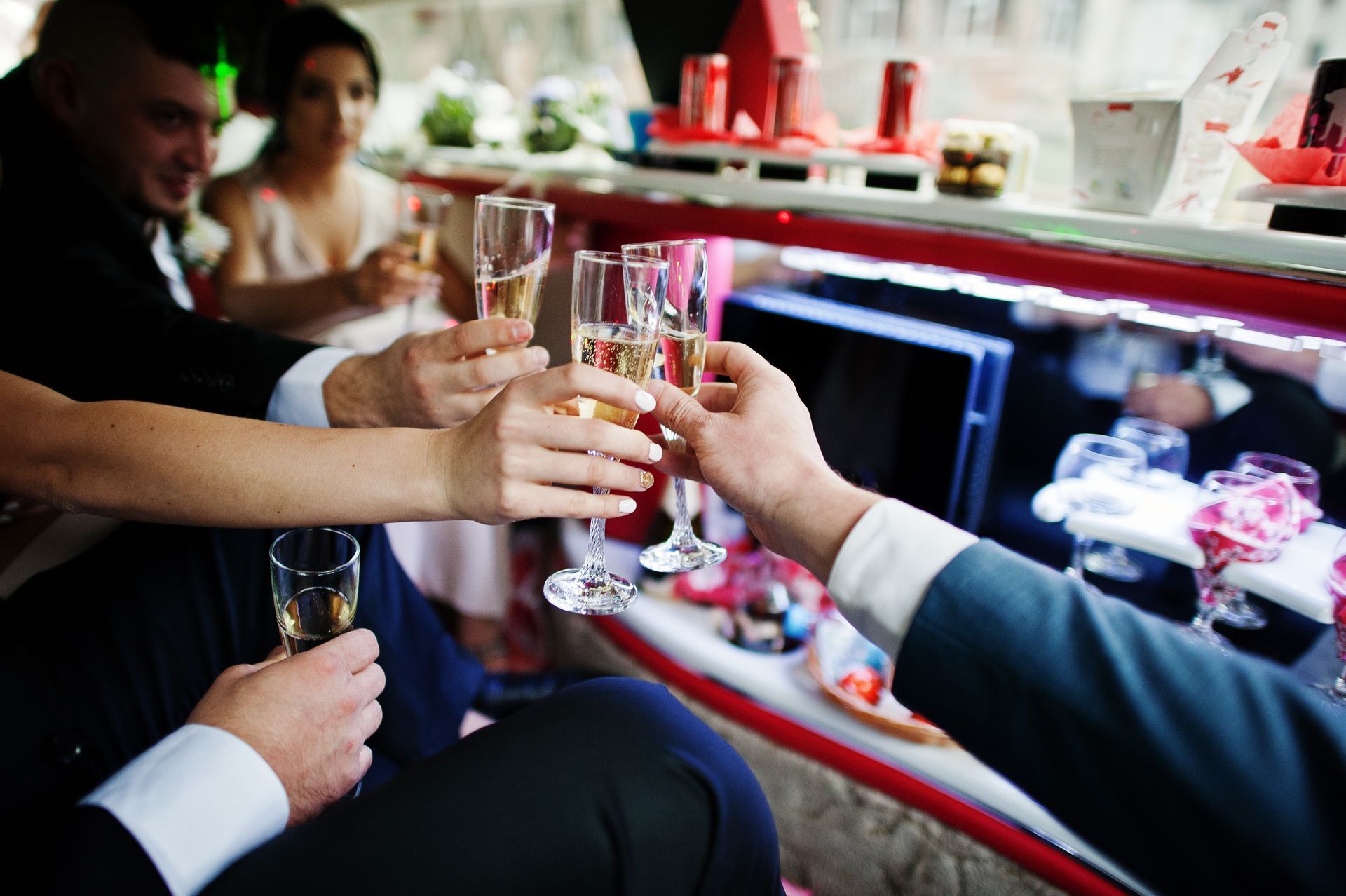 A group of people are toasting with champagne glasses in a limousine.