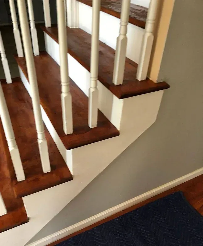 A staircase with wooden steps and white railing