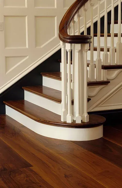 A wooden staircase with a white railing and wooden steps