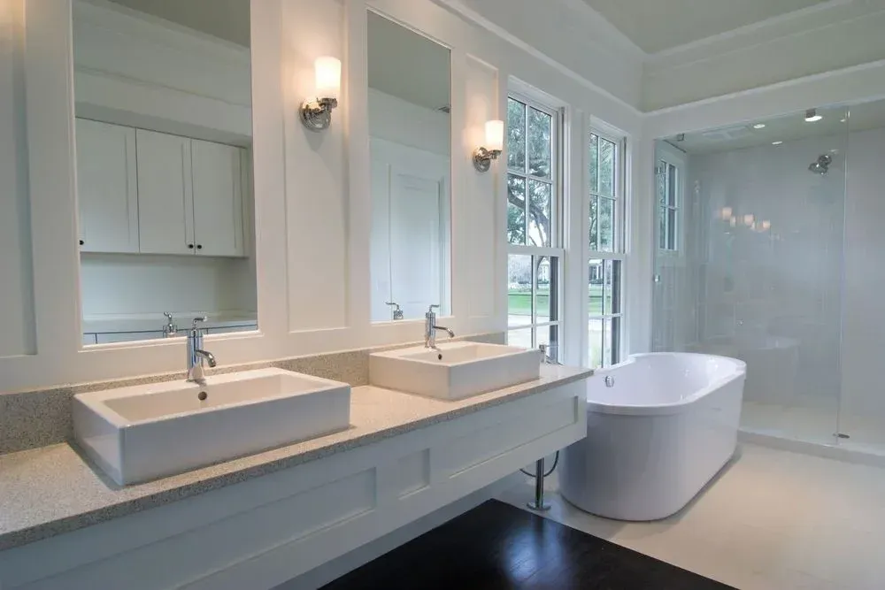 A bathroom with two sinks and a bathtub