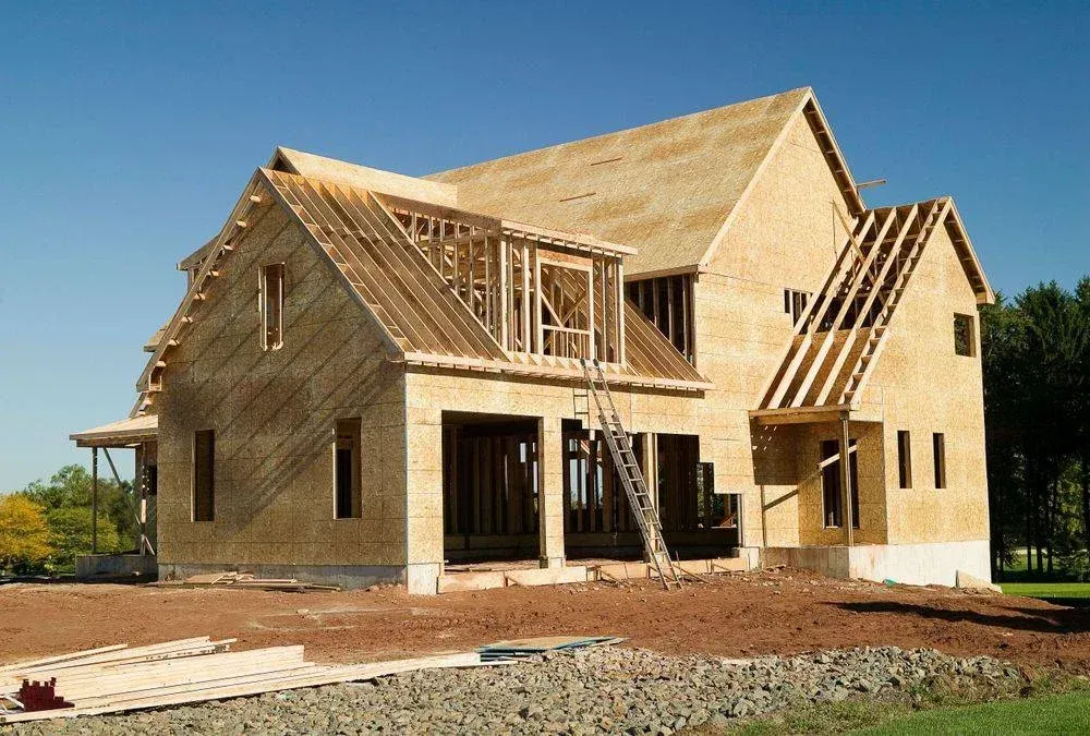 A house that is being built with a blue sky in the background