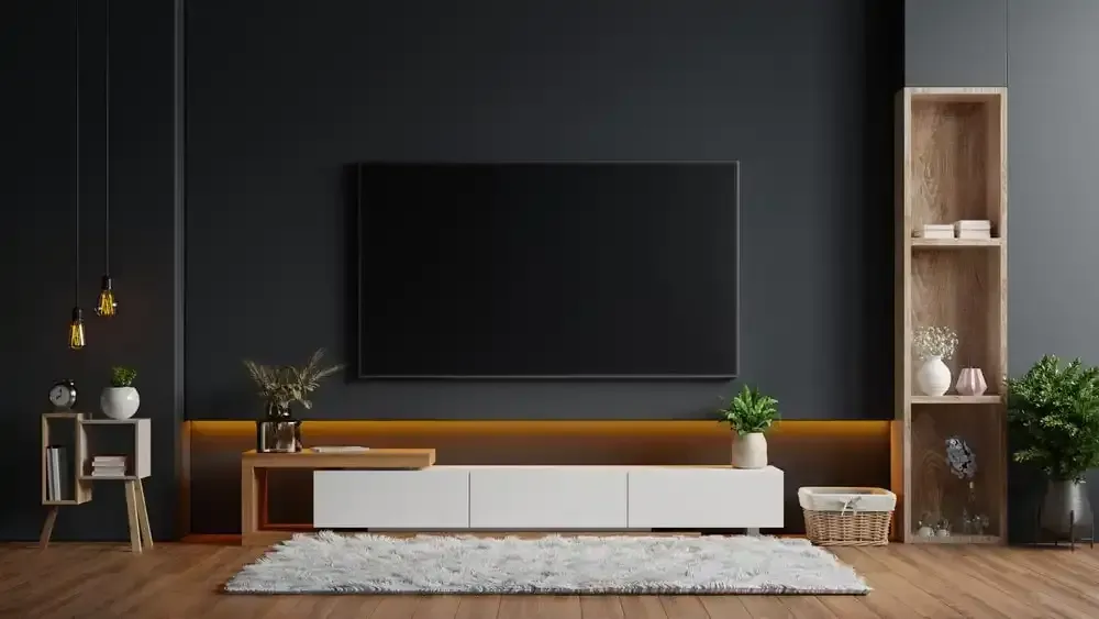 Modern living room with black wall, large TV, white media console, wood accents, and shaggy rug.
