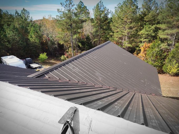 The roof of a house with trees in the background