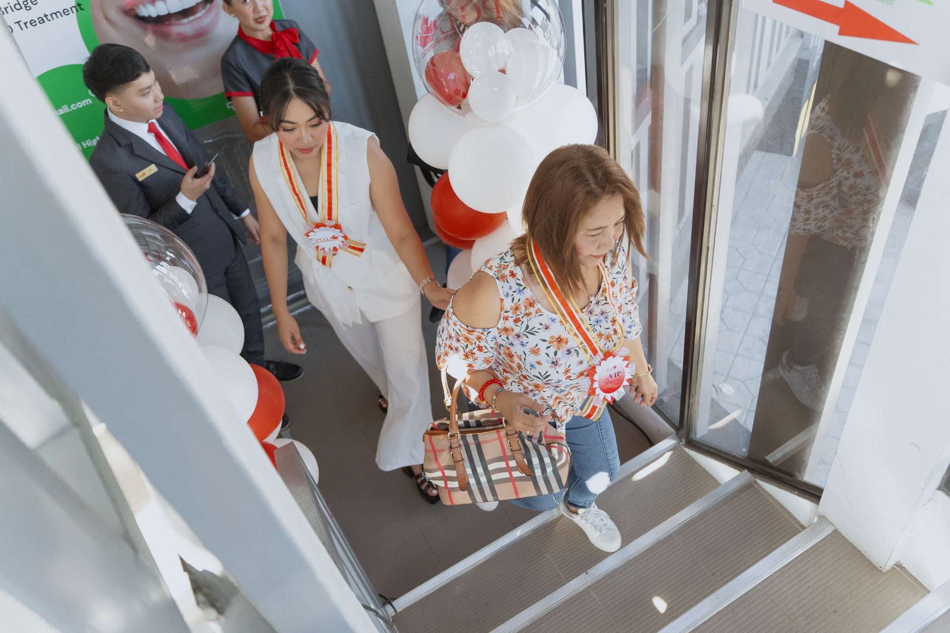 A group of people are walking down a set of stairs.