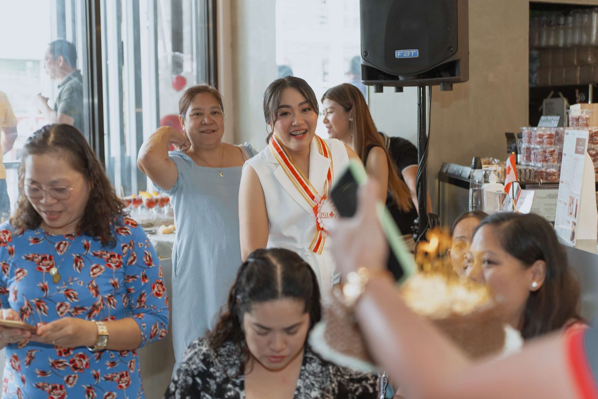 A group of women are standing around a table at a party.