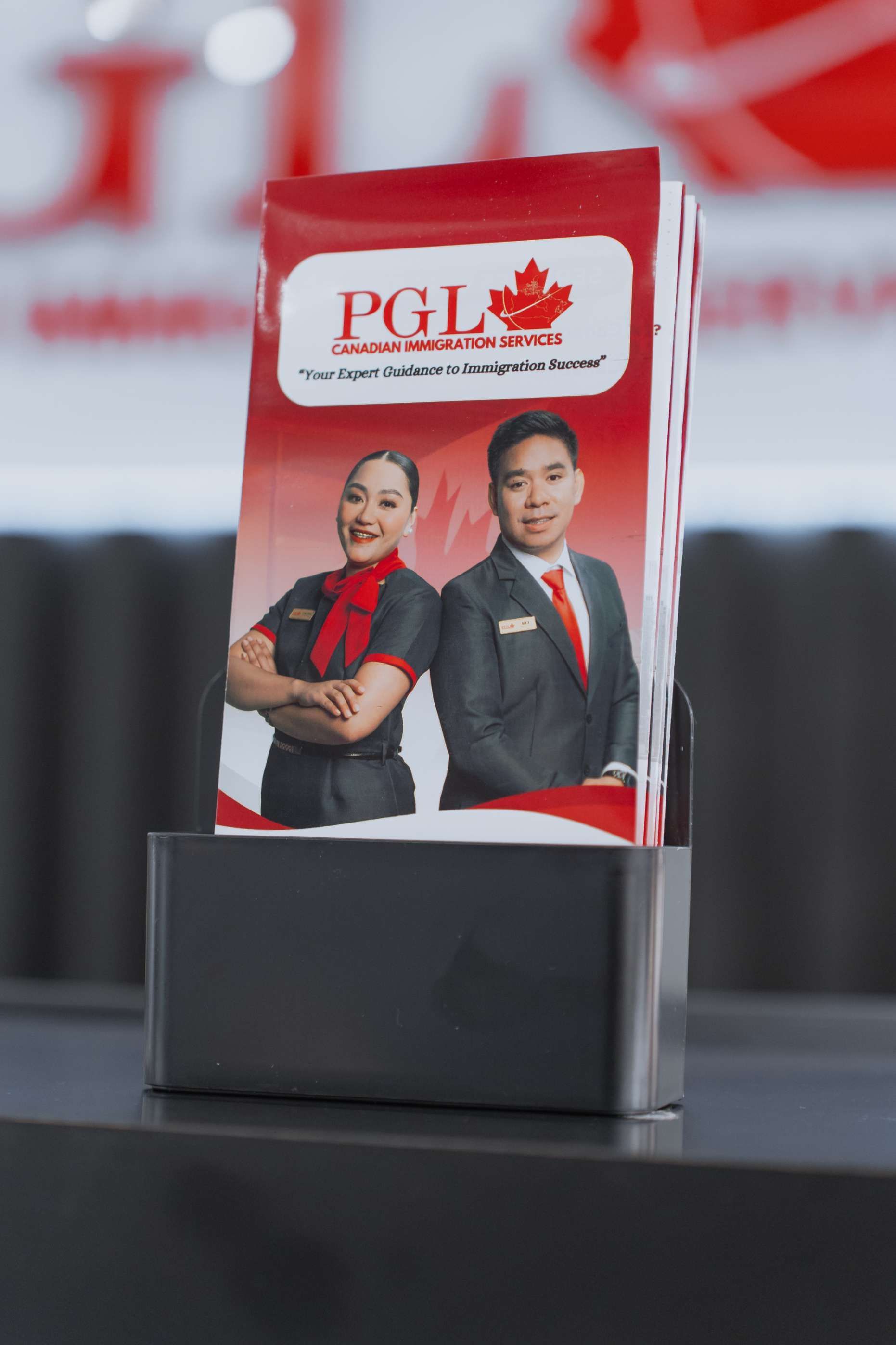 A man and a woman are standing next to each other in a brochure holder.