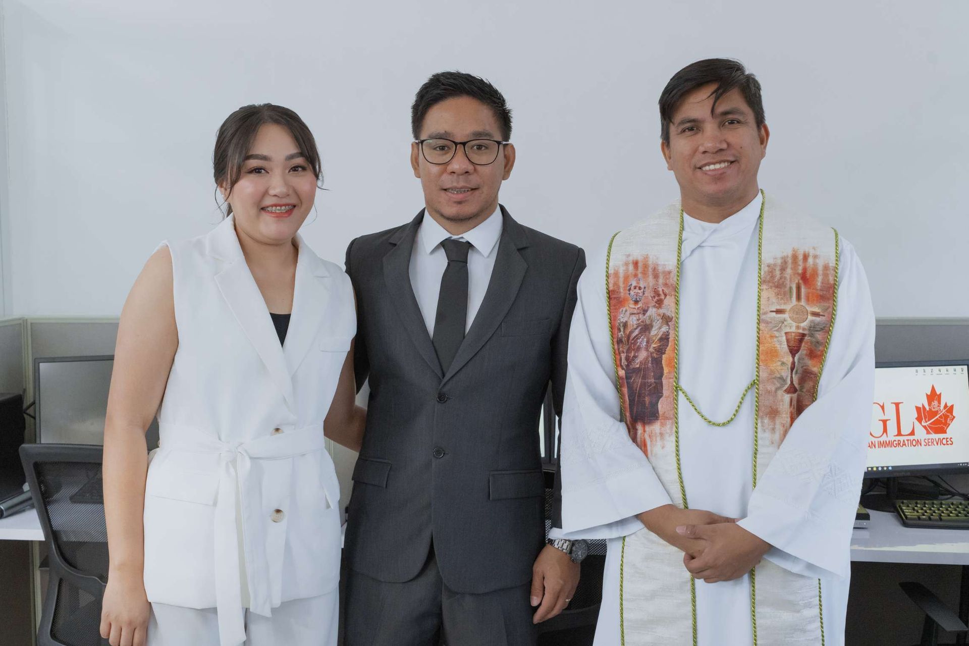 A group of people standing next to each other in a room.