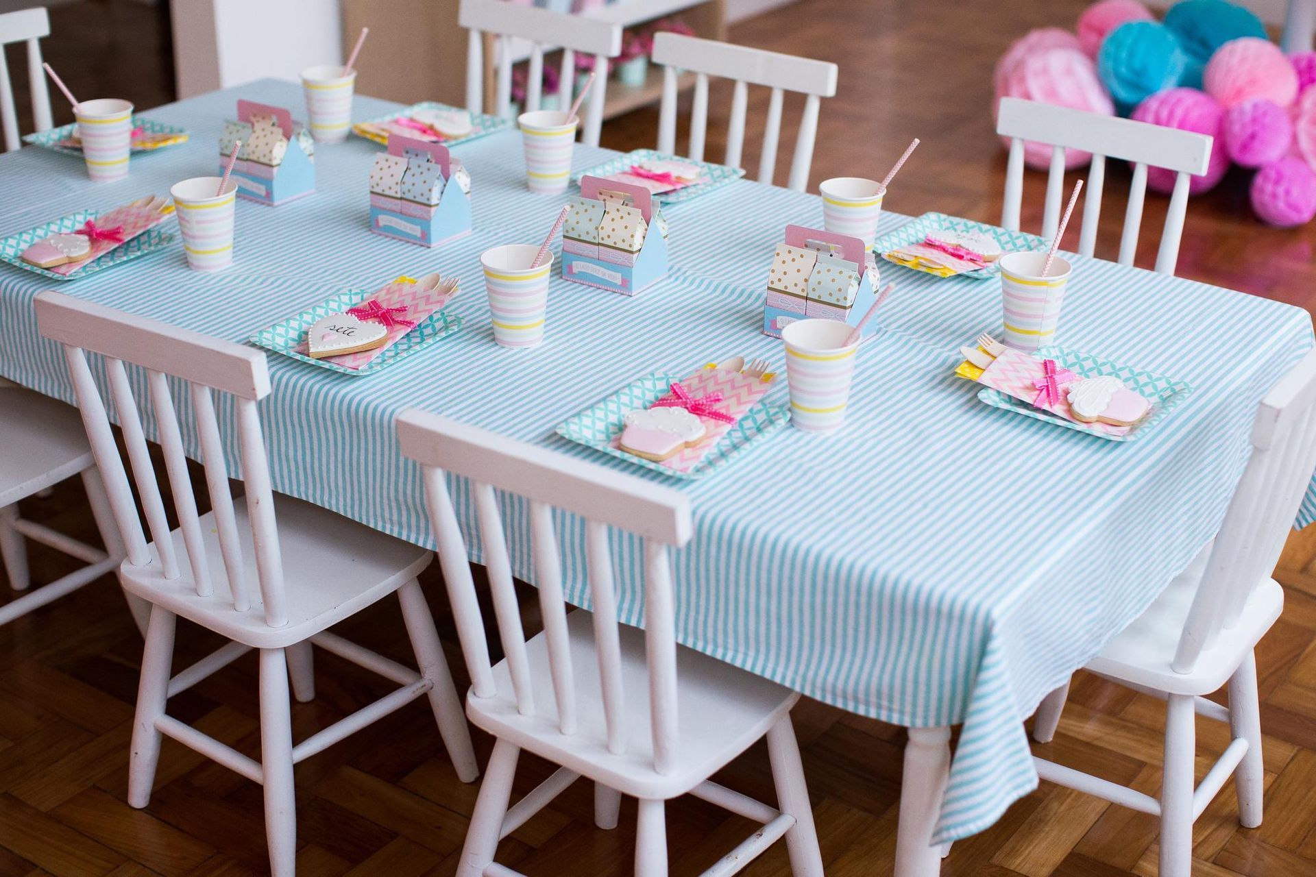 A table set for a birthday party with plates , cups , and napkins.