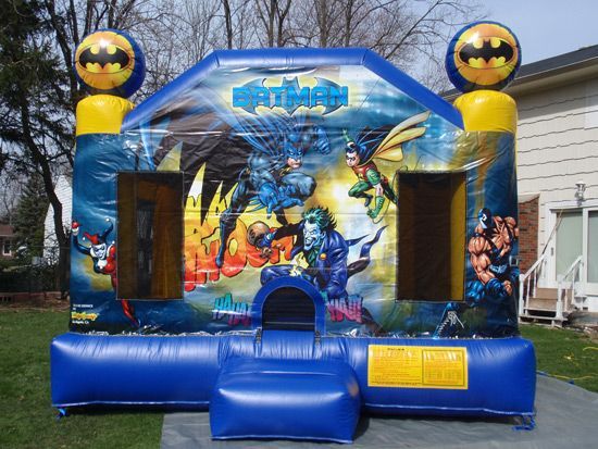 A blue bouncy house with a batman theme on it