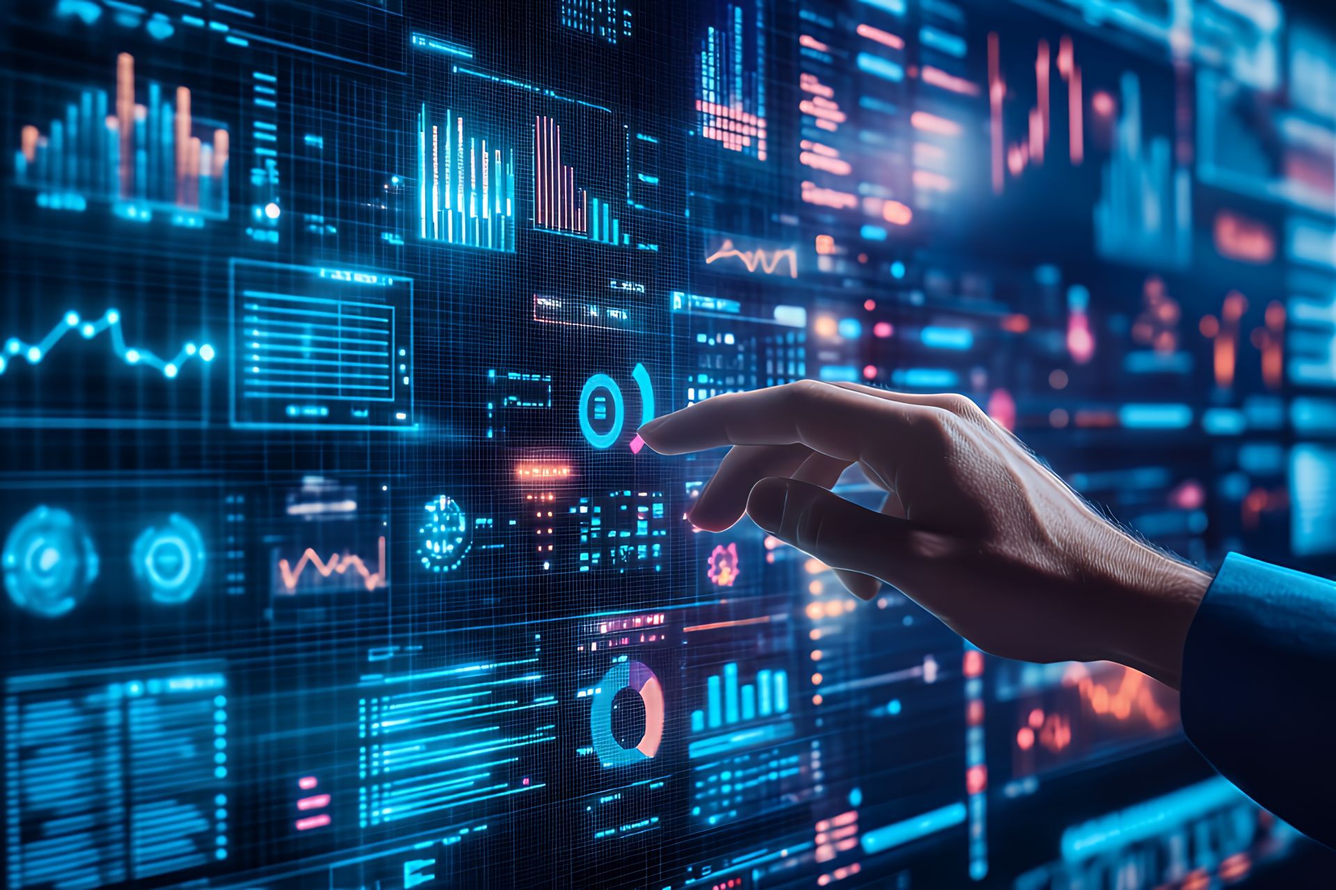 Hand pointing at a data visualization display, blue and orange graphs, charts, and digital readouts.
