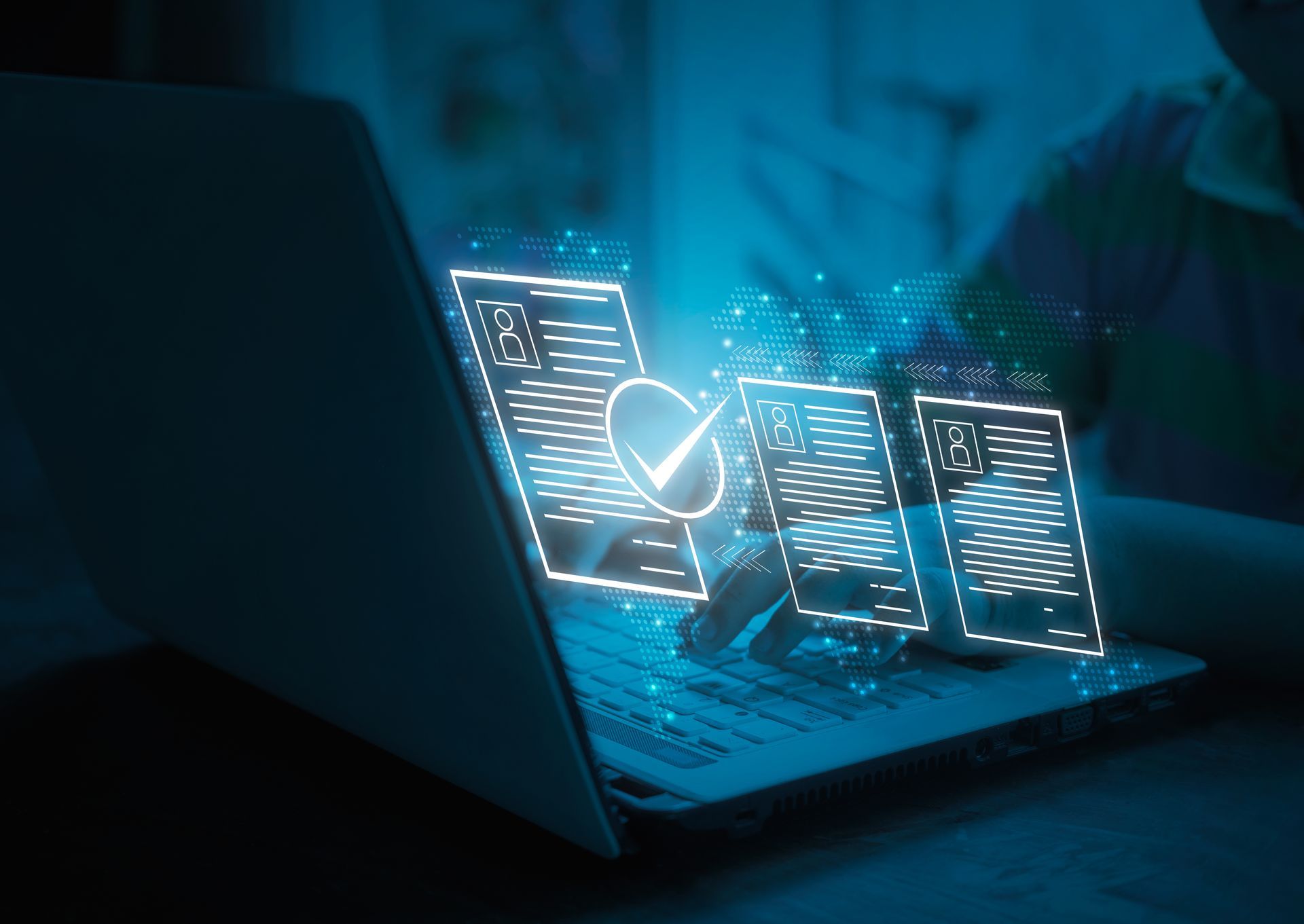 Laptop with glowing documents and a checkmark, suggesting online document approval.