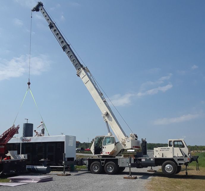 A large white truck with a crane attached to it
