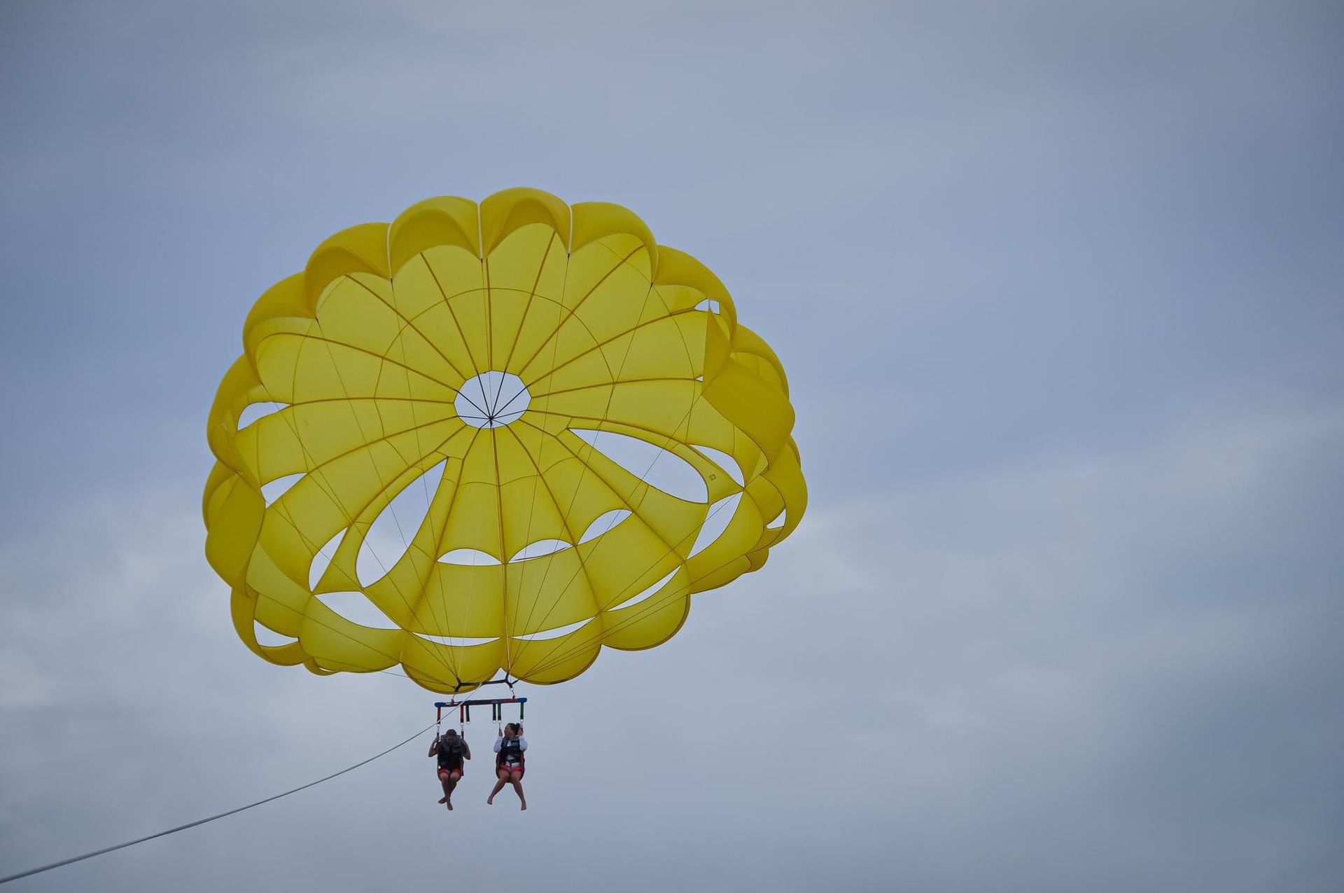Customers enjoying parasailing over lake michigan
