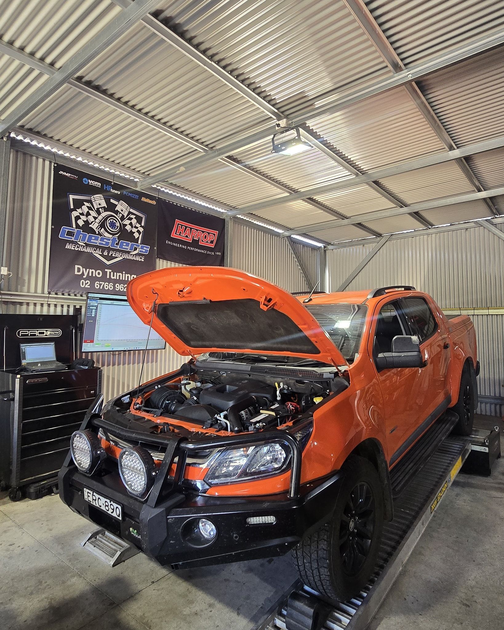 Orange Truck With Hood Open on a Dyno, in a Garage Setting — Chester's Mechanical & Performance in Tamworth, NSW