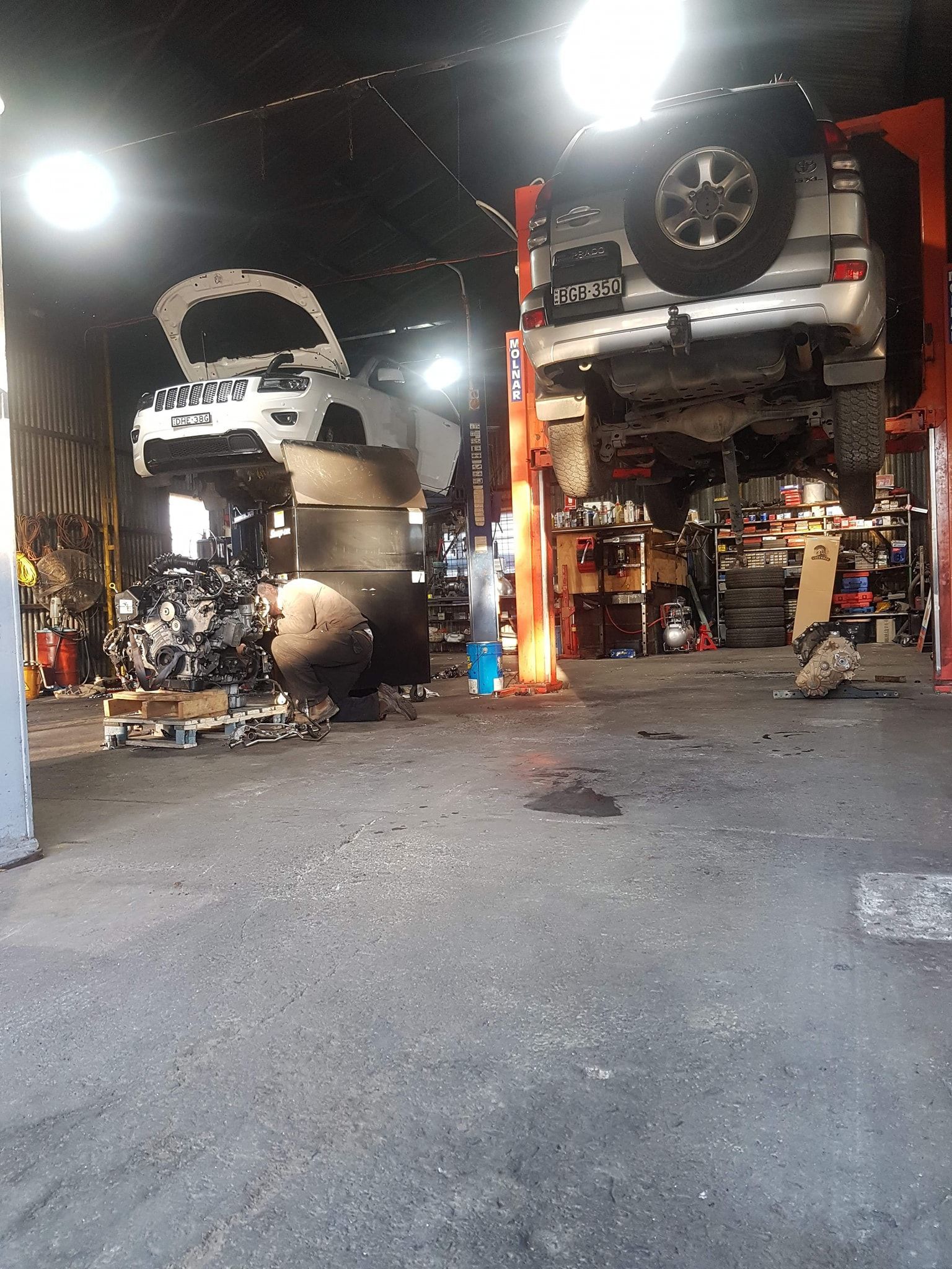 Two Vehicles on Lifts in a Garage. One Has Its Hood Open — Chester's Mechanical & Performance in Tamworth, NSW