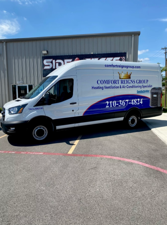 White van with Comfort Reigns Group logo parked in front of a building.