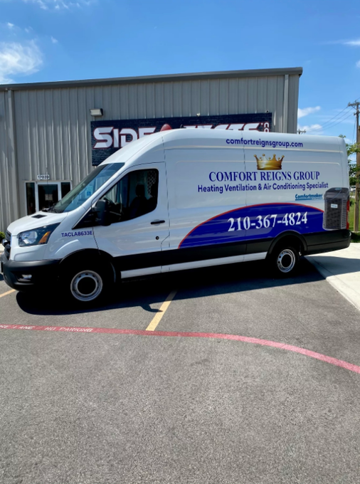 White van with Comfort Reigns Group logo parked in front of a building.