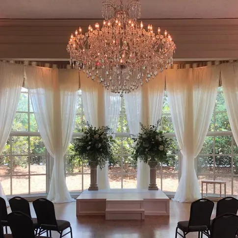 There is a large chandelier in the middle of the room.