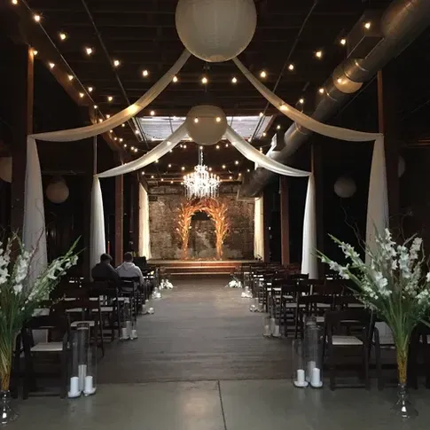 A wedding ceremony is taking place in a dark room