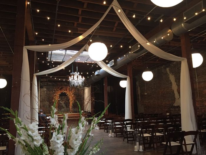 A wedding ceremony is taking place in a large room