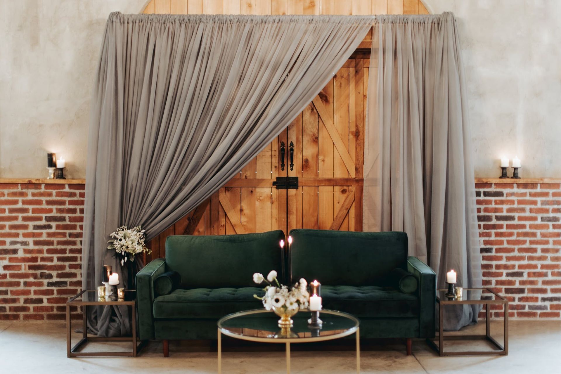 There is a couch and a table in front of a wooden door.