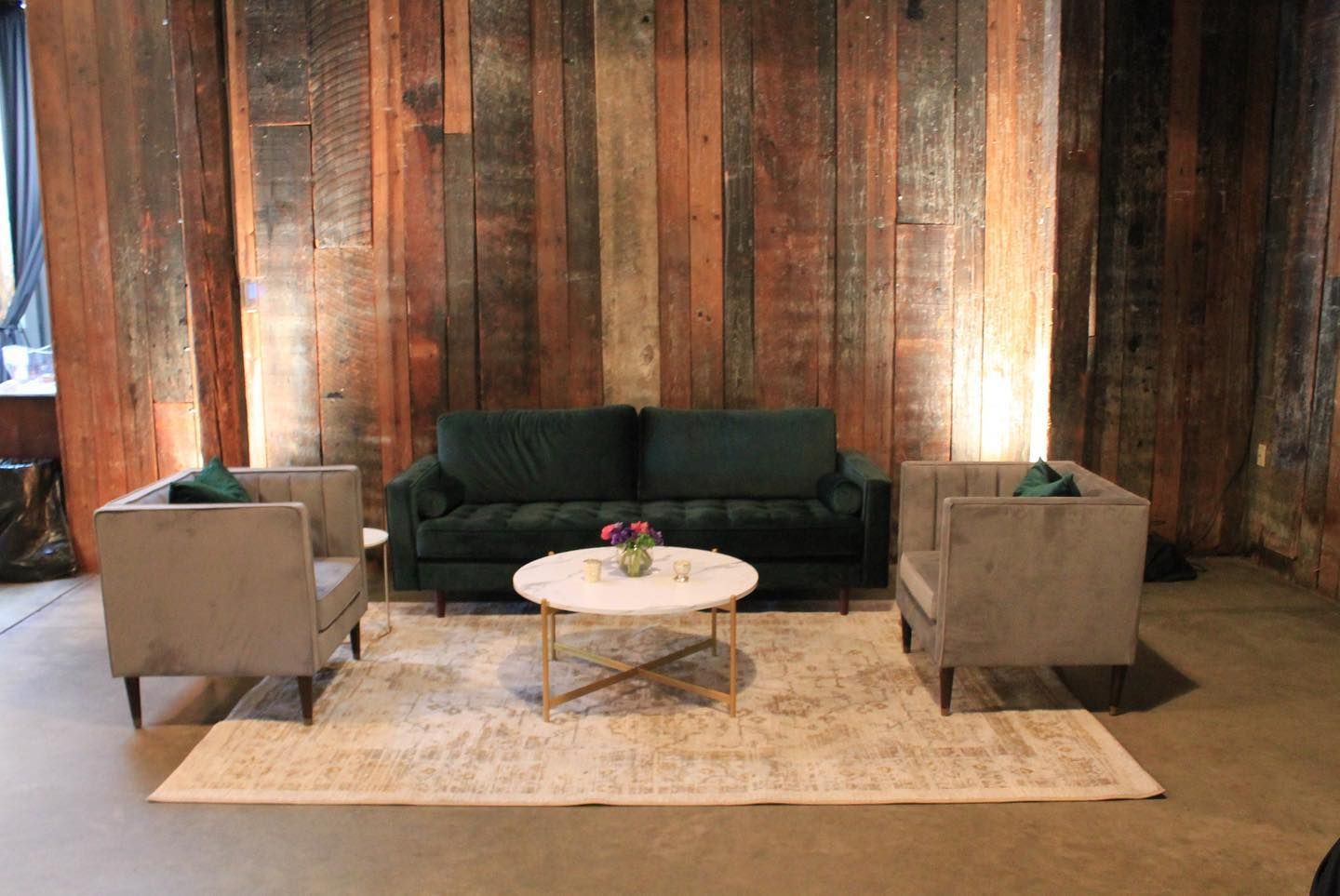 A living room with a couch , two chairs , and a coffee table.